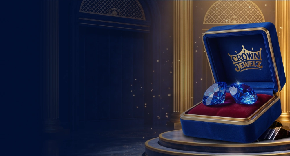 Open blue velvet box holding two sapphires, branded Crown Jewelz
